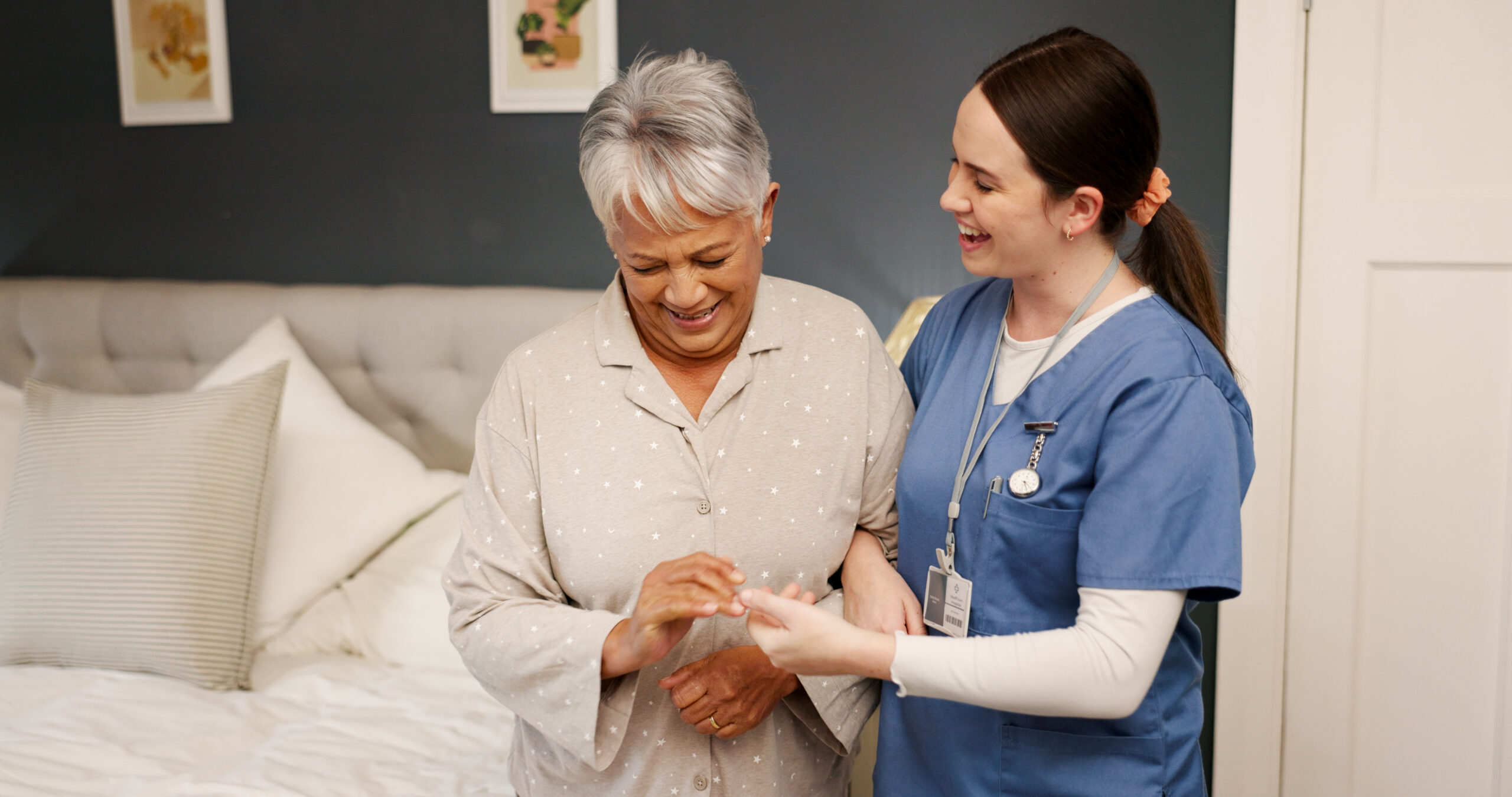 Home, senior woman and caregiver with support for medical wellness, nursing or assistance for walking. Bedroom, elderly person and nurse with help for balance, mobility care or patient with arthritis